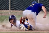 Lemoore's Anfernee Murrieta dives into third base under the tag of Exeter High's Hank Williams in Wednesday playoff opener.